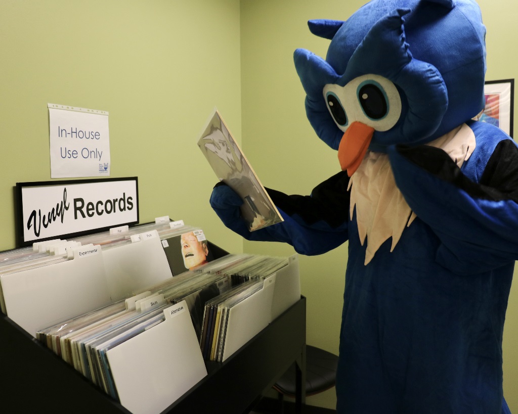 Whooo Looks at Records WFPL mascot, Whooo, looks at vinyl record collection
